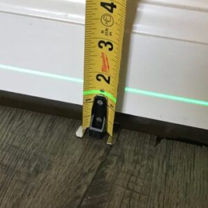 Sagging floors interior of house tape measure and laser level closeup scaled 1 Sagging floors interior of house tape measure and laser level closeup scaled 1